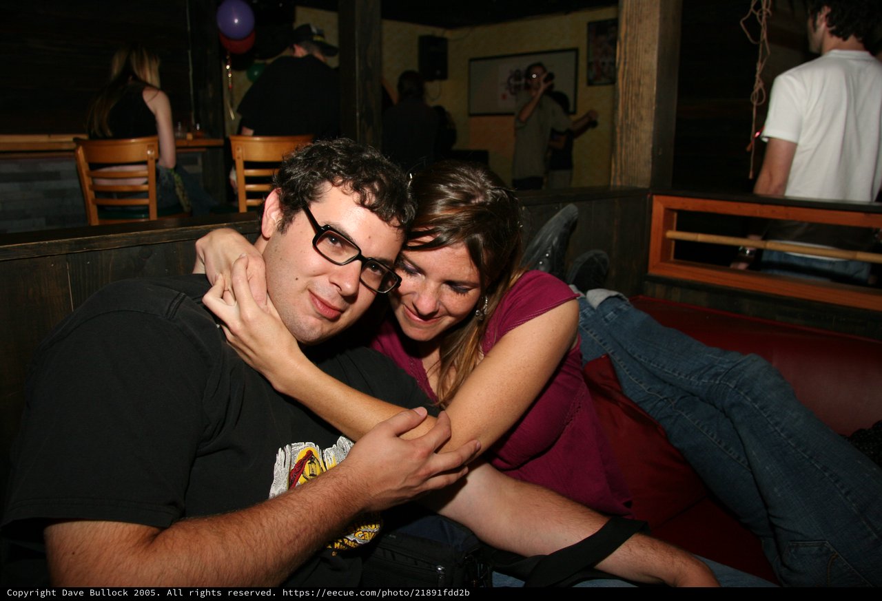 Couple Sharing Intimate Moment at Bar Booth