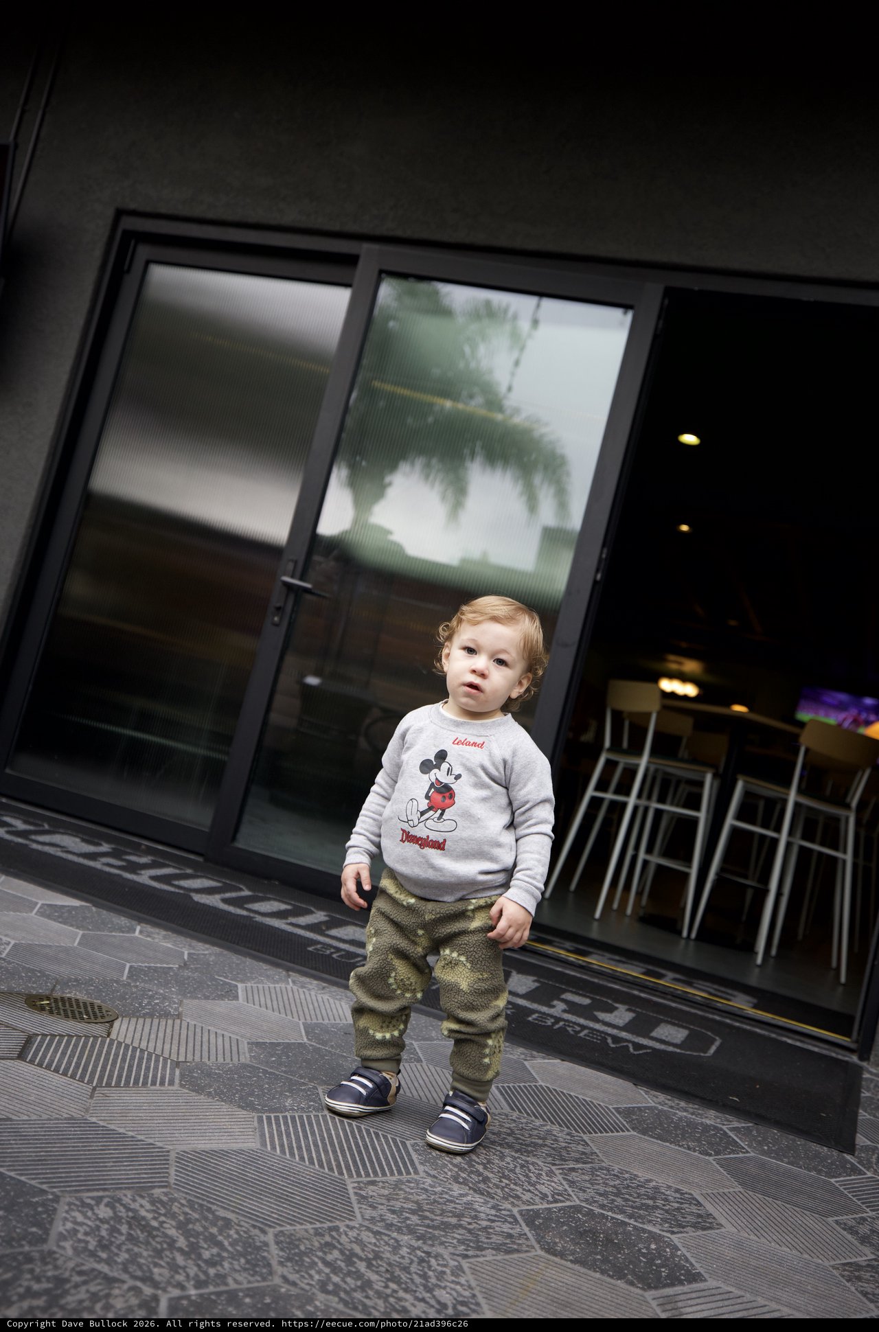 Young Child Outside Modern Storefront in SLO