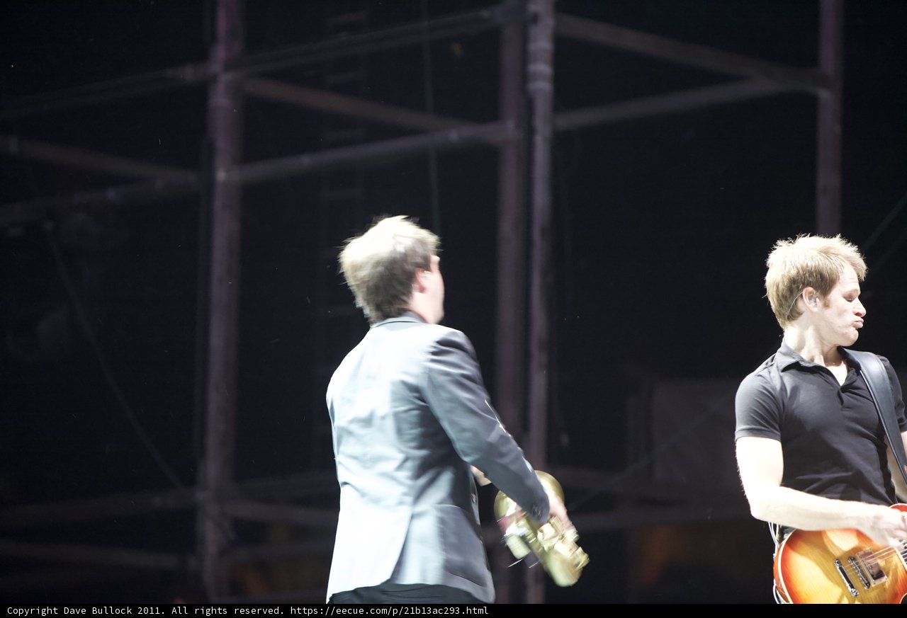 Two Men Rocking the Crowd with their Guitars