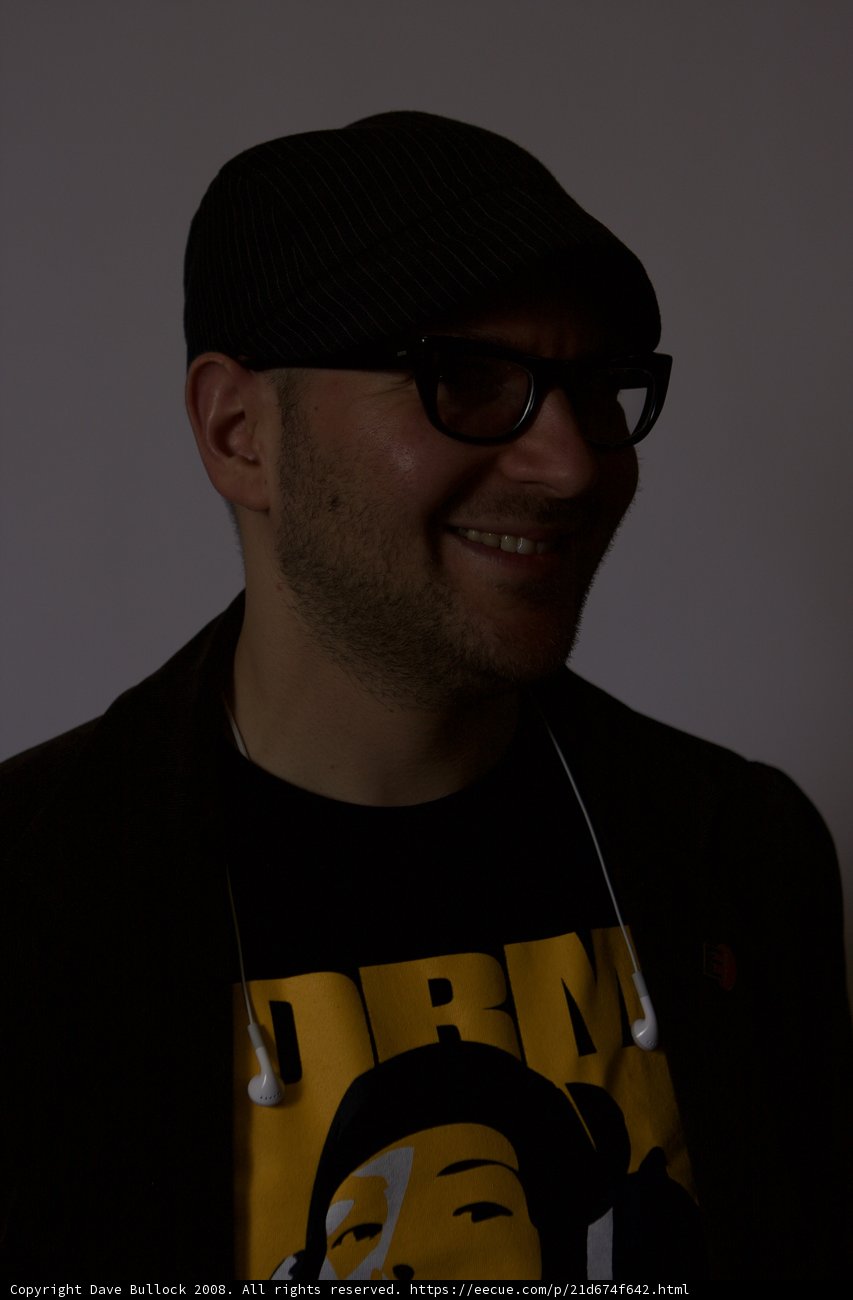 Smiling man in black hat and glasses