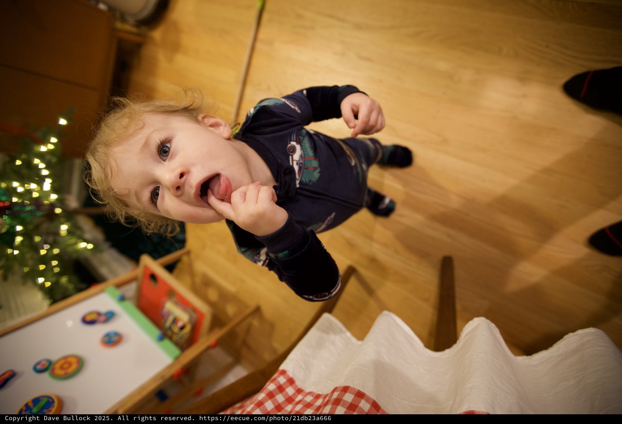 Joyful Toddler Enjoying Lollipop on Christmas Morning