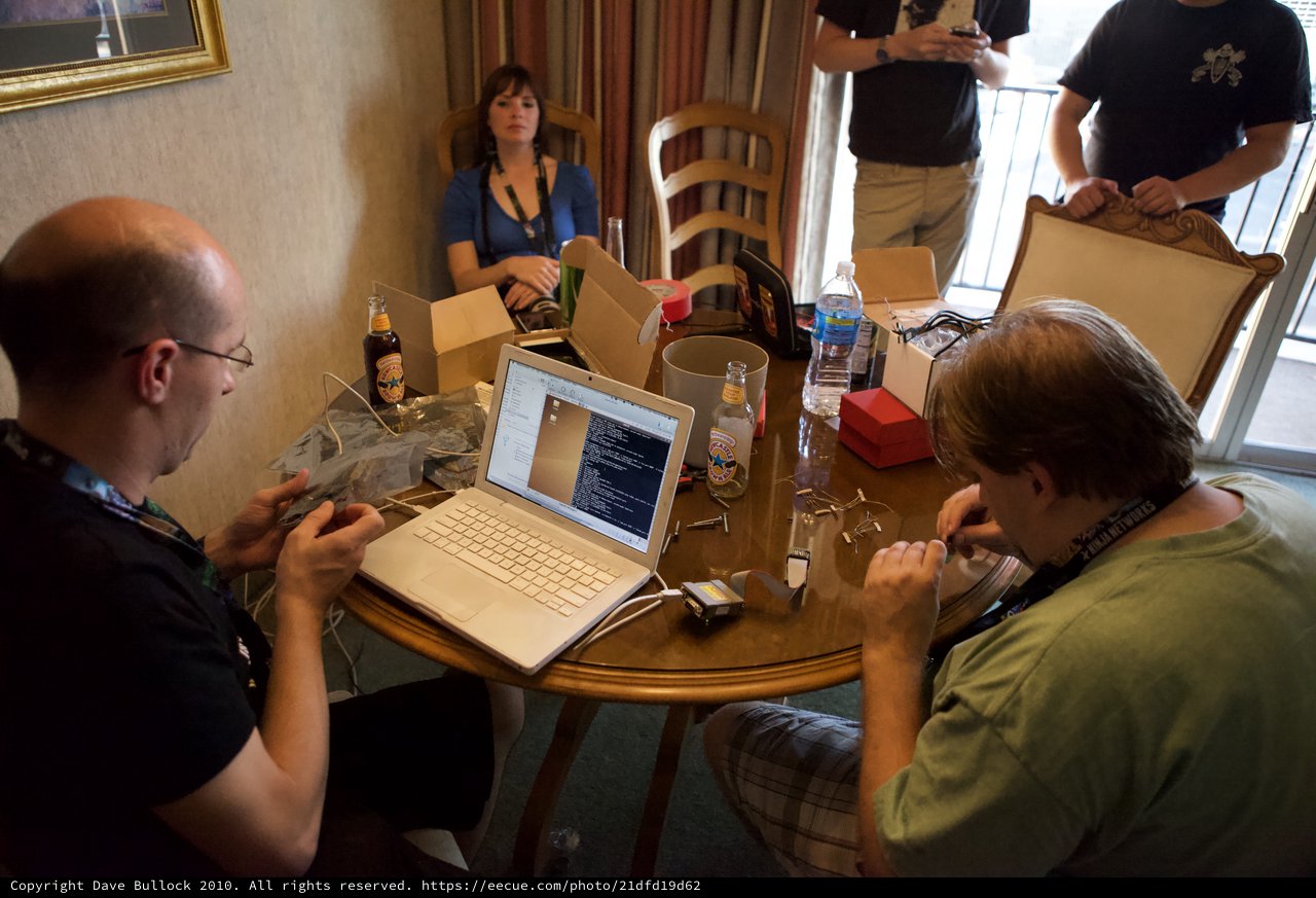Hackers Gather Around Laptop at DEF CON 18