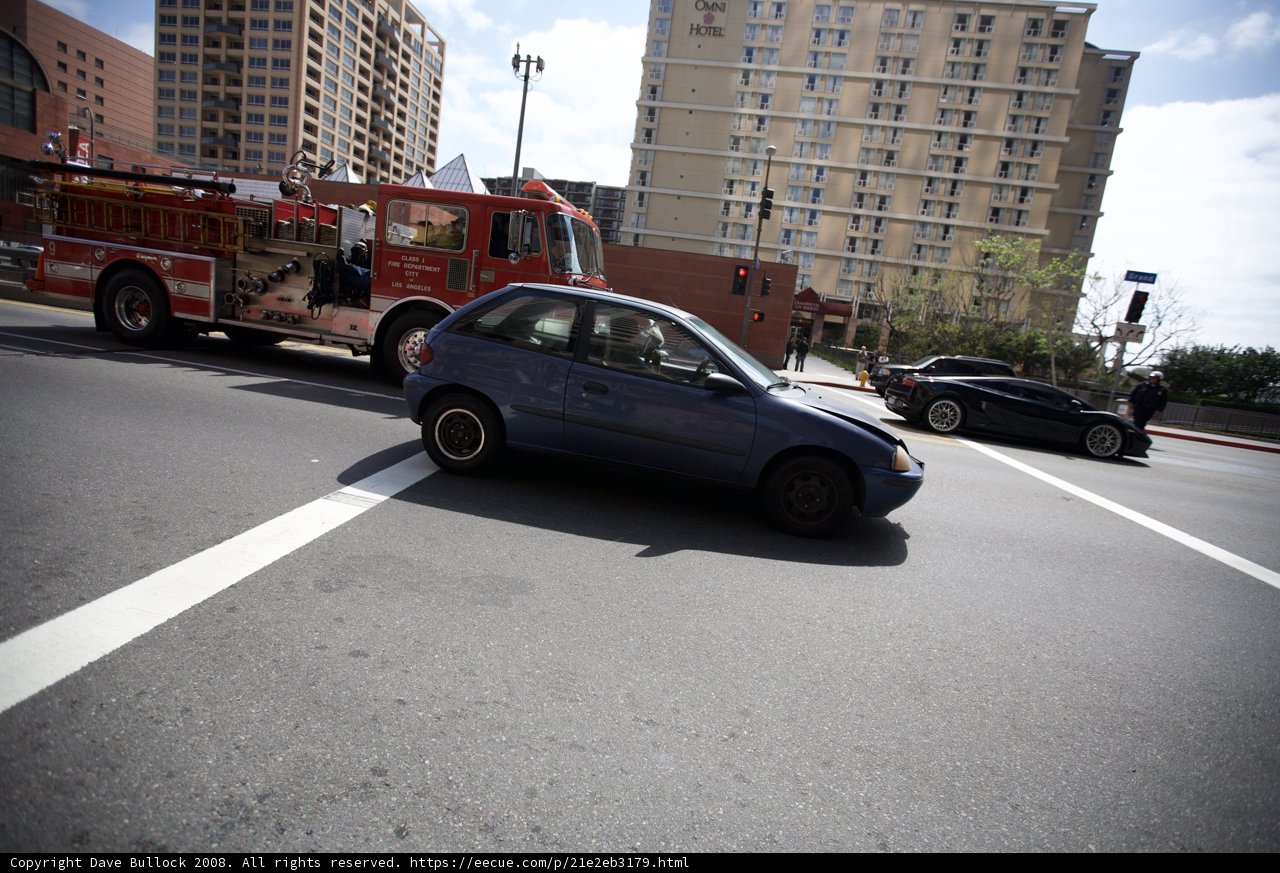 Blue Car Paused at Crosswalk