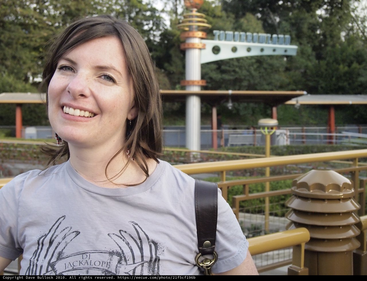 Smiling Woman at Tomorrowland Disneyland Entrance