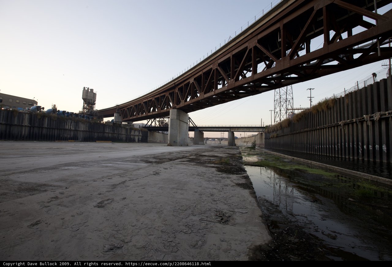 Bridge over Canal with City Skyline