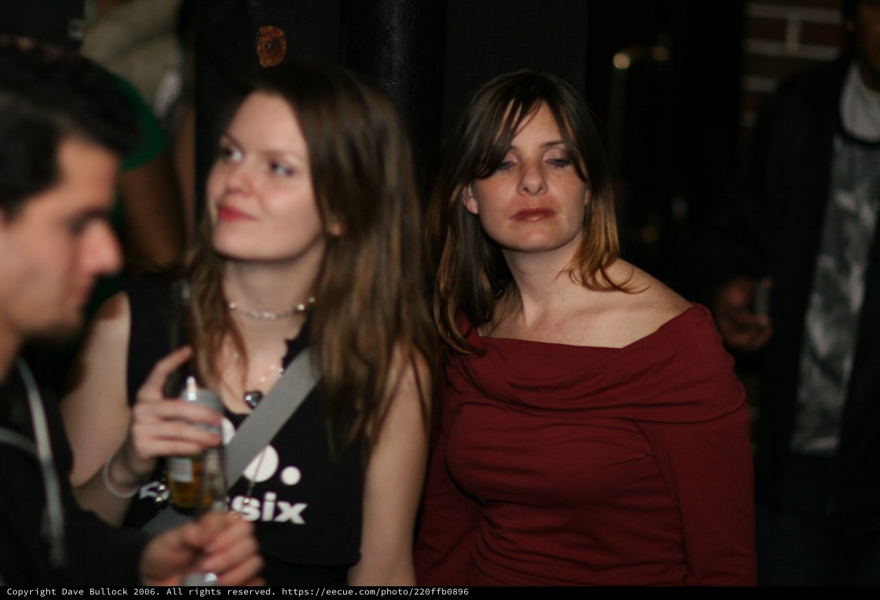 Two Women at a Dimly Lit Nightclub Event