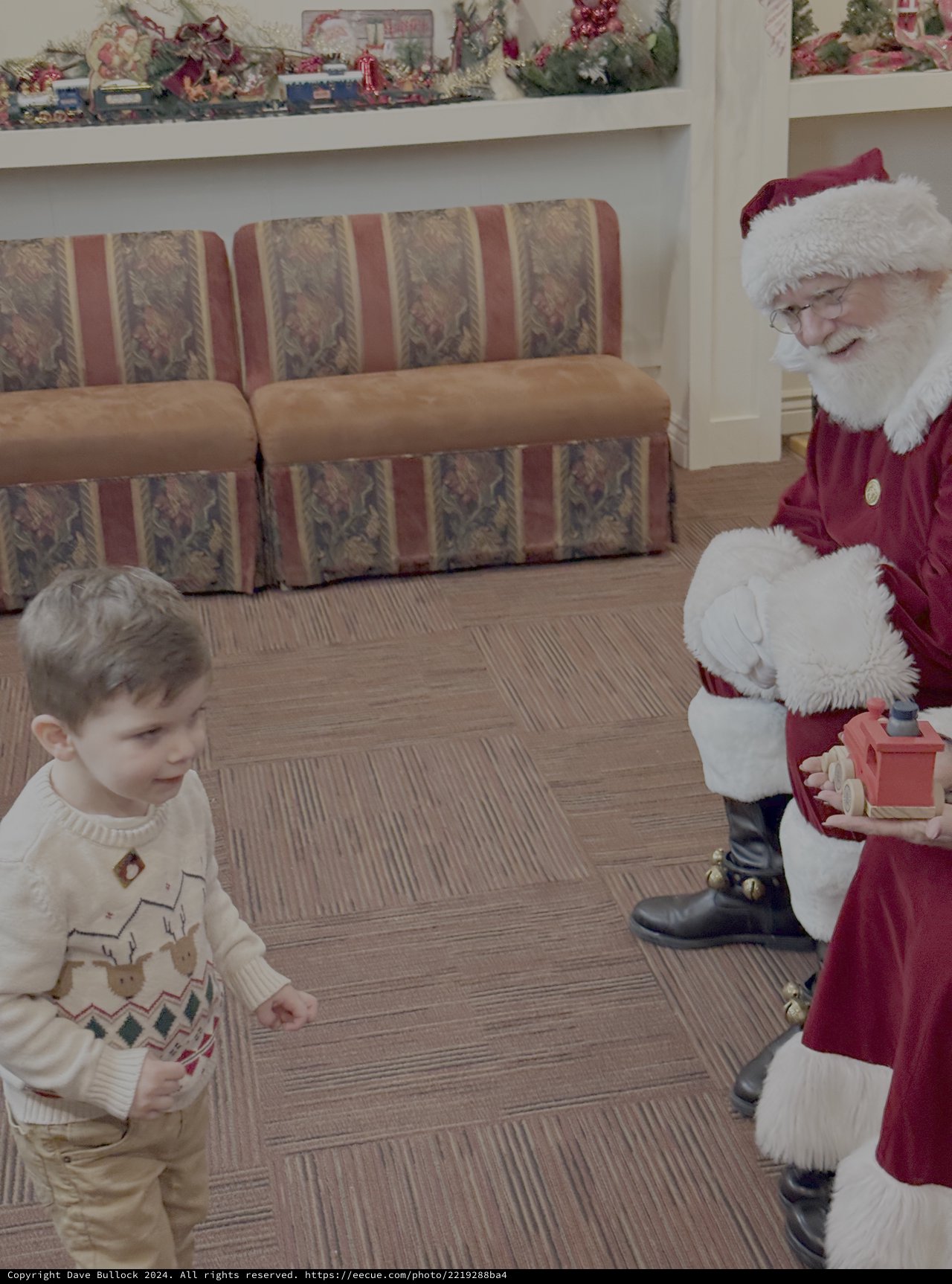 Child Meets Santa Claus at Christmas Gathering