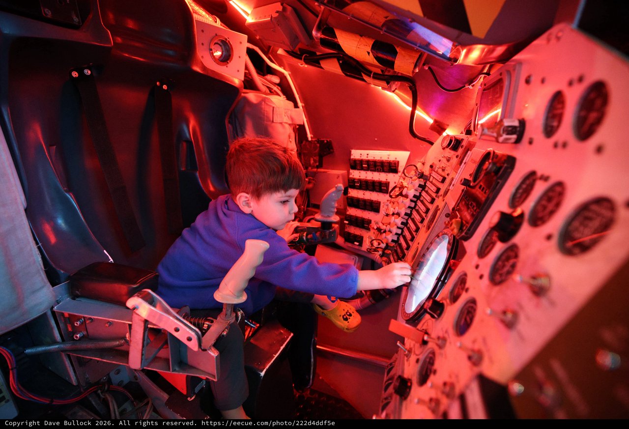 Child Exploring Submarine Simulator at Science Center