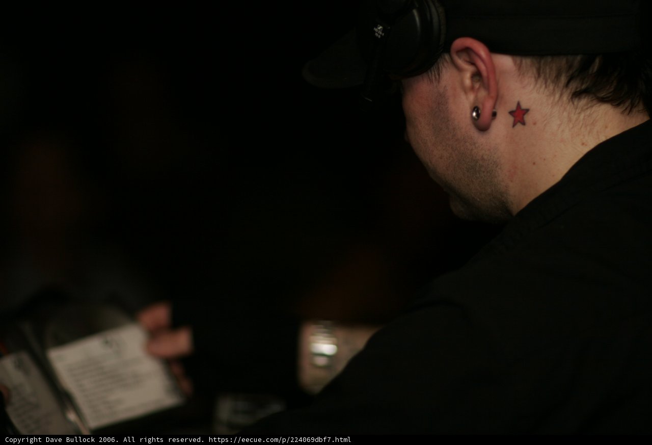 Tattooed Man Listening to Music