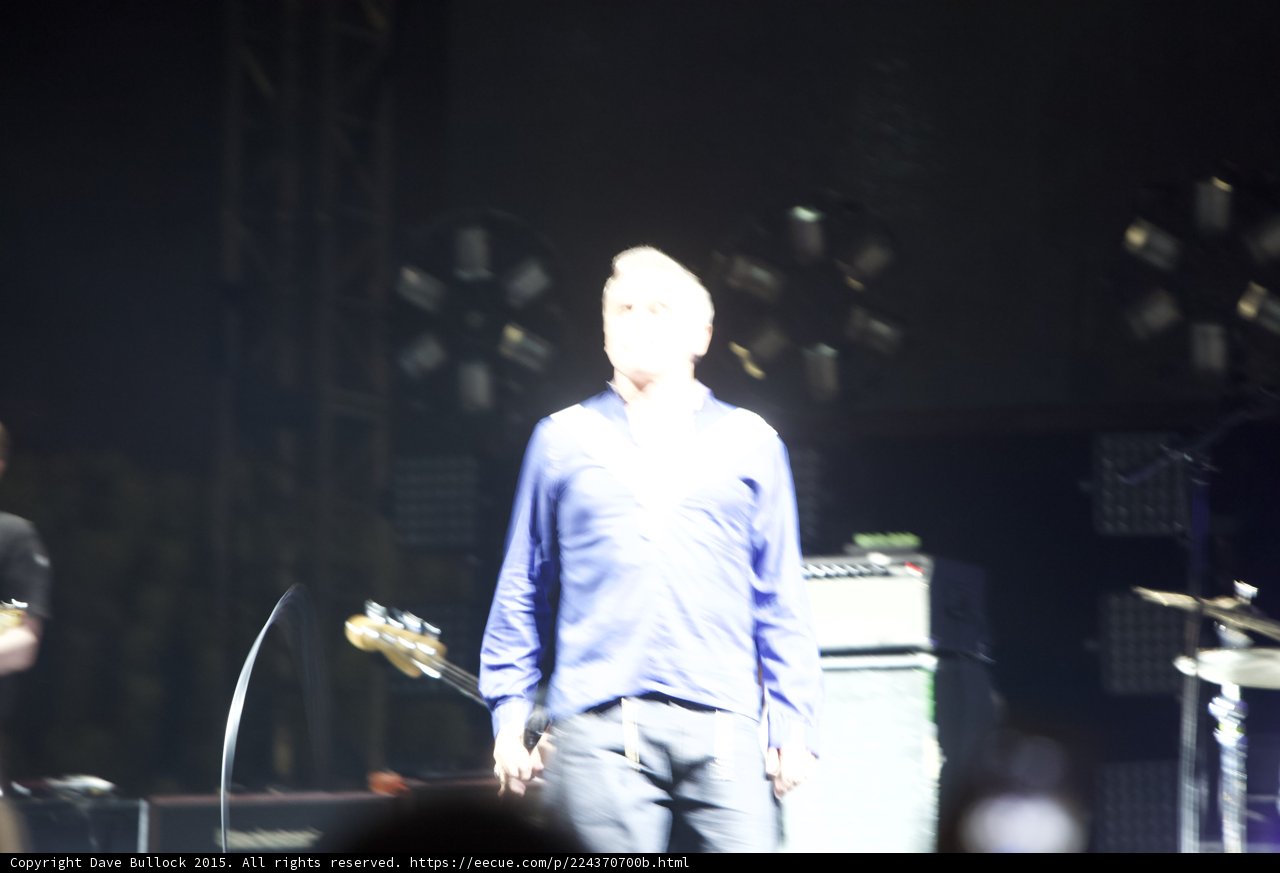 Morrissey Motion Blur Standing Blue Shirt Bassist Mic Cord Drums Scaffolding Stage Lights