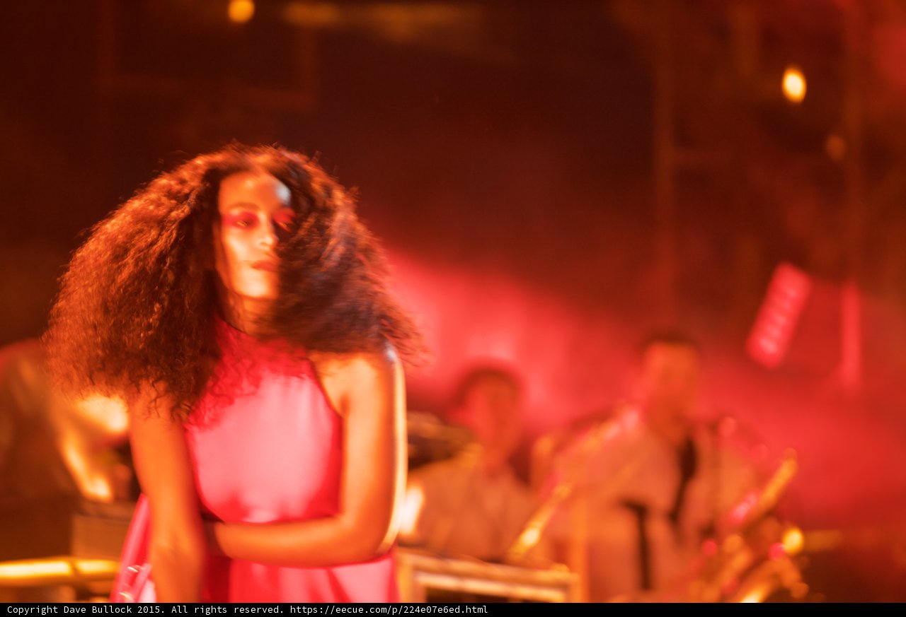Solange Portrait Hair Motion Looking Down Band Background Red