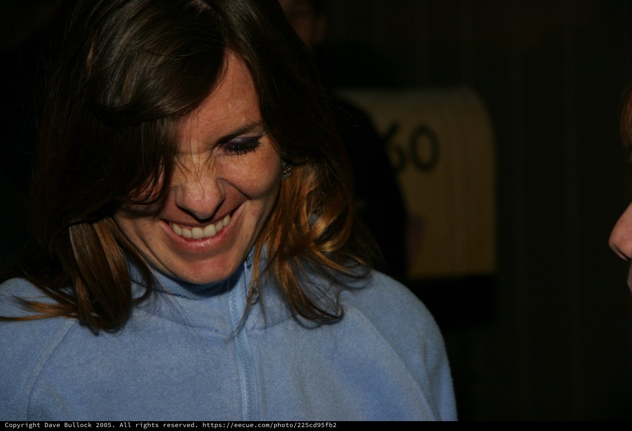 Candid Smile: Woman in Blue Fleece Looking Down