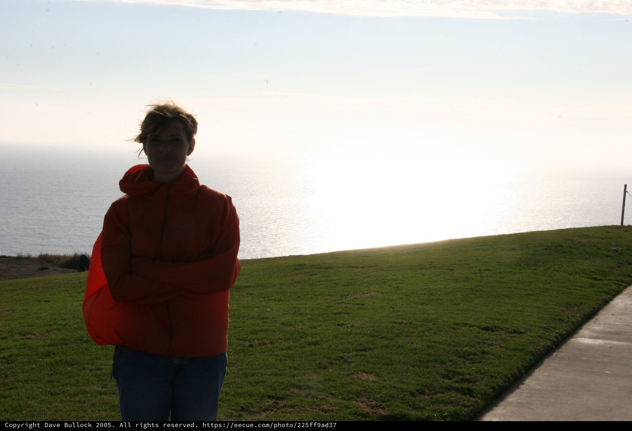 Windswept Woman at Coastal Cliff Overlook