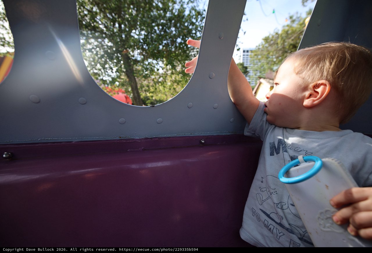 Young Boy Looking Through Playground Structure Window