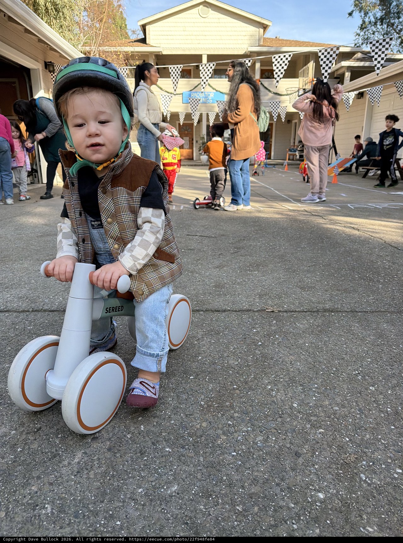 Young Child on Balance Bike at Neighborhood Party
