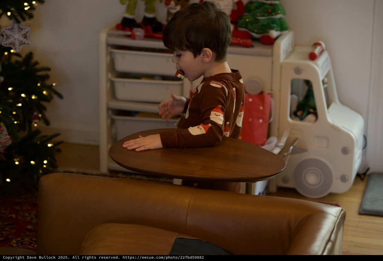 Young Boy in Festive Pajamas at Christmas Play Table