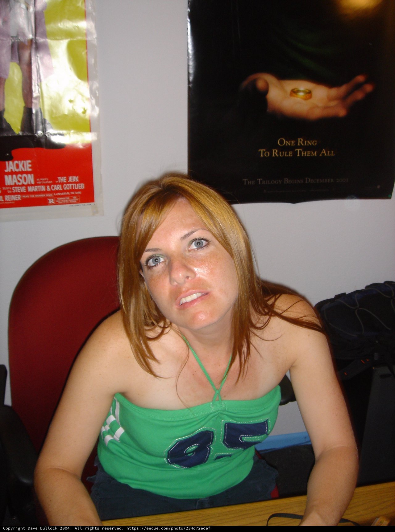 Young Woman Seated Beneath Lord of the Rings Poster