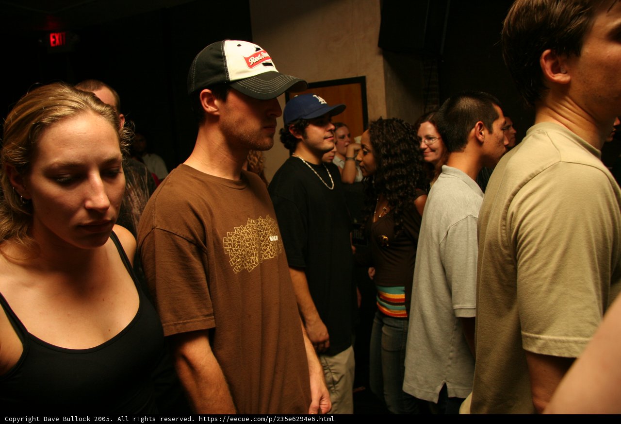 Hat-Wearing Man Joins the Crowd