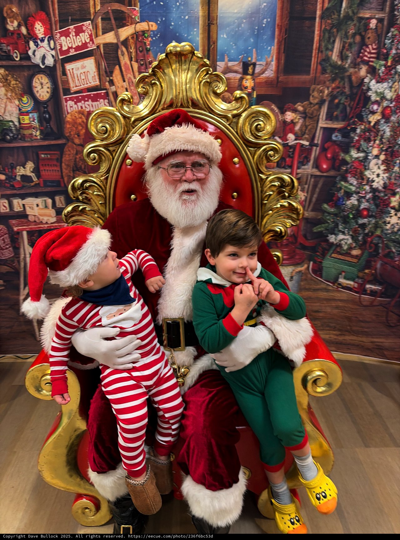 Two Children Visit Santa in His Workshop Throne