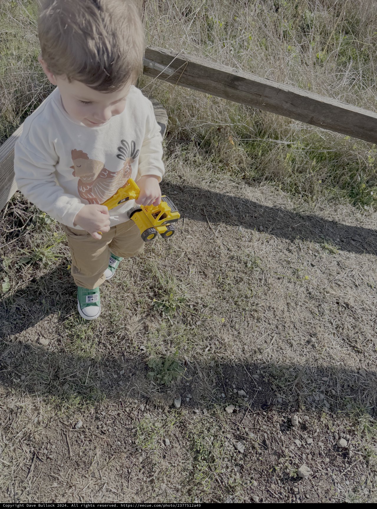 Child Playing with Toy Truck Outdoors