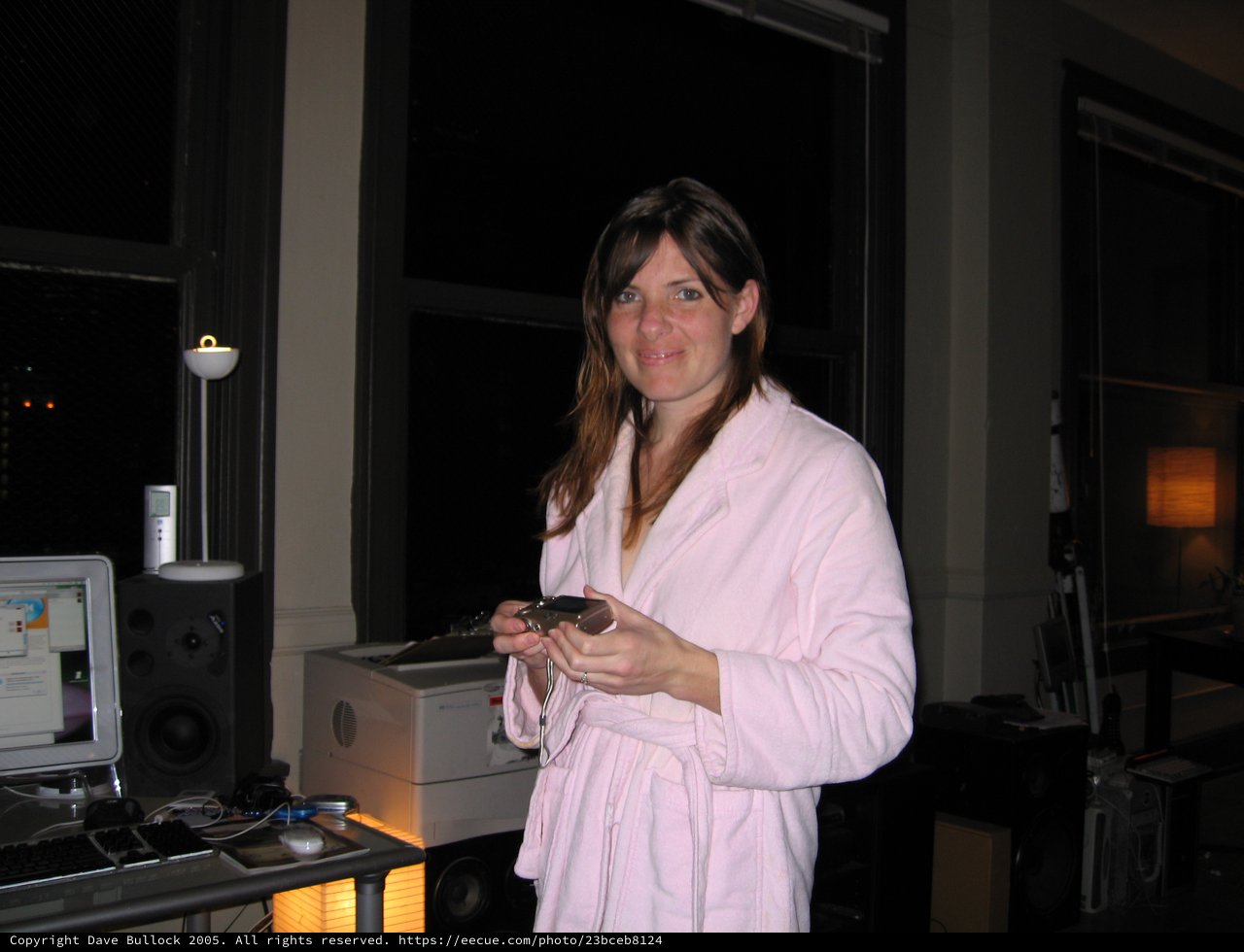 Woman in Pink Robe at Home Tech Setup