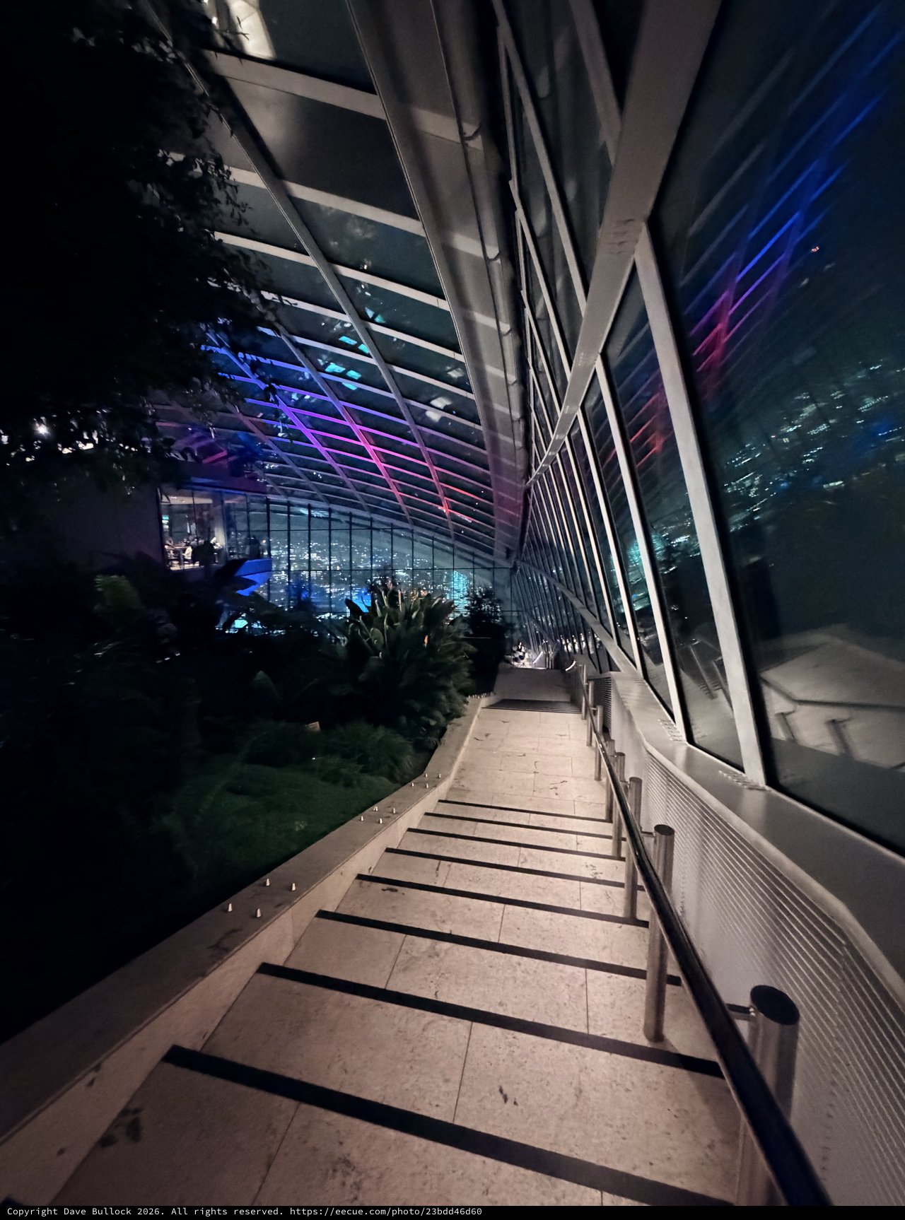 Modern Architectural Stairway with Neon-Lit Sky Garden at Night