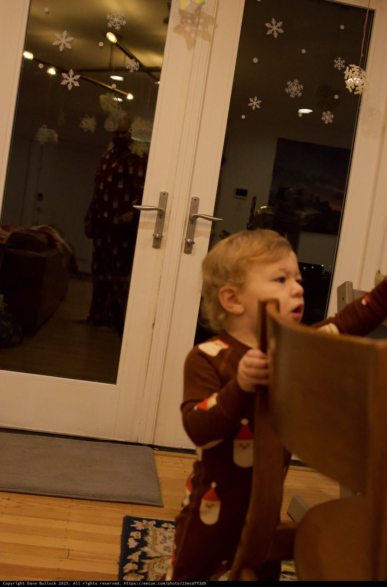 Young Child Opening French Doors on Christmas Day
