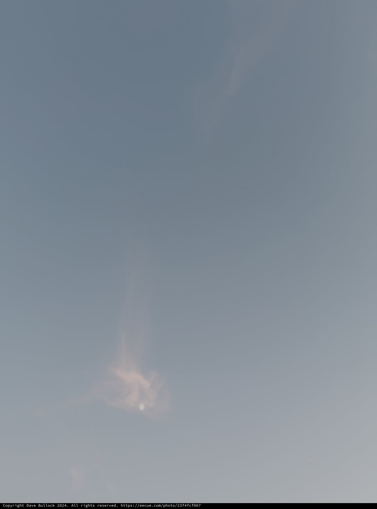 Faint Moon Through Heavy Overcast Sky