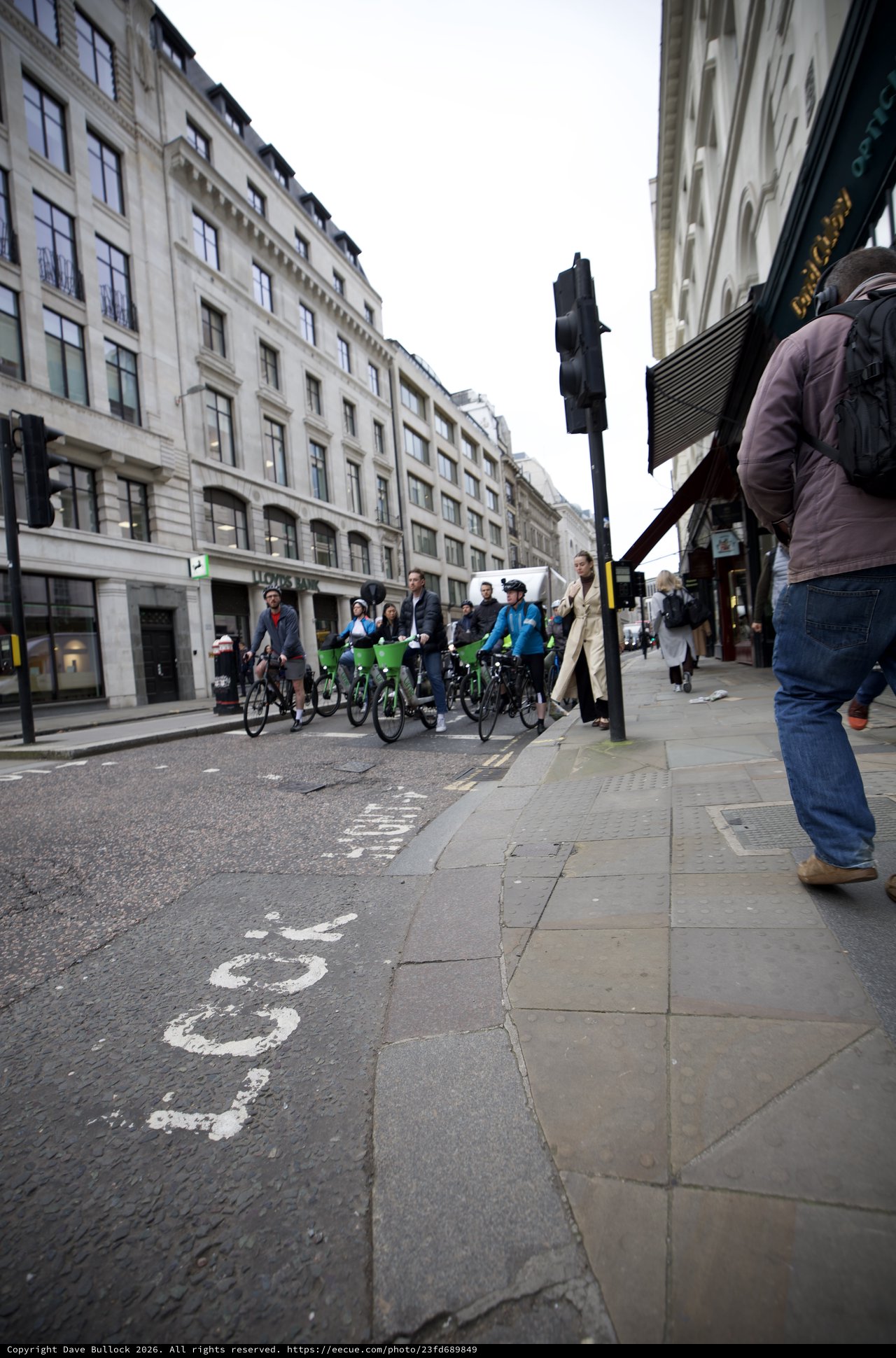 Cyclists on London Street with Classical Architecture