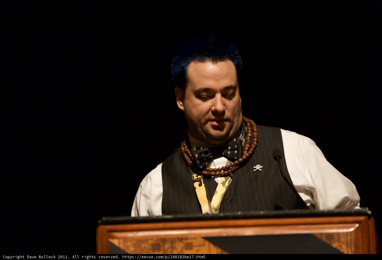 Blue-Haired Man at the Podium