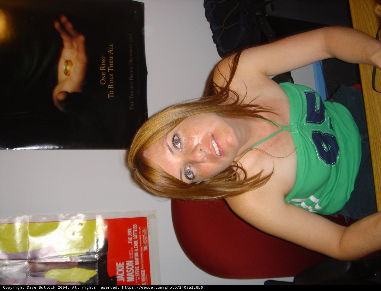 Young Woman Posing Sideways with Lord of the Rings Poster