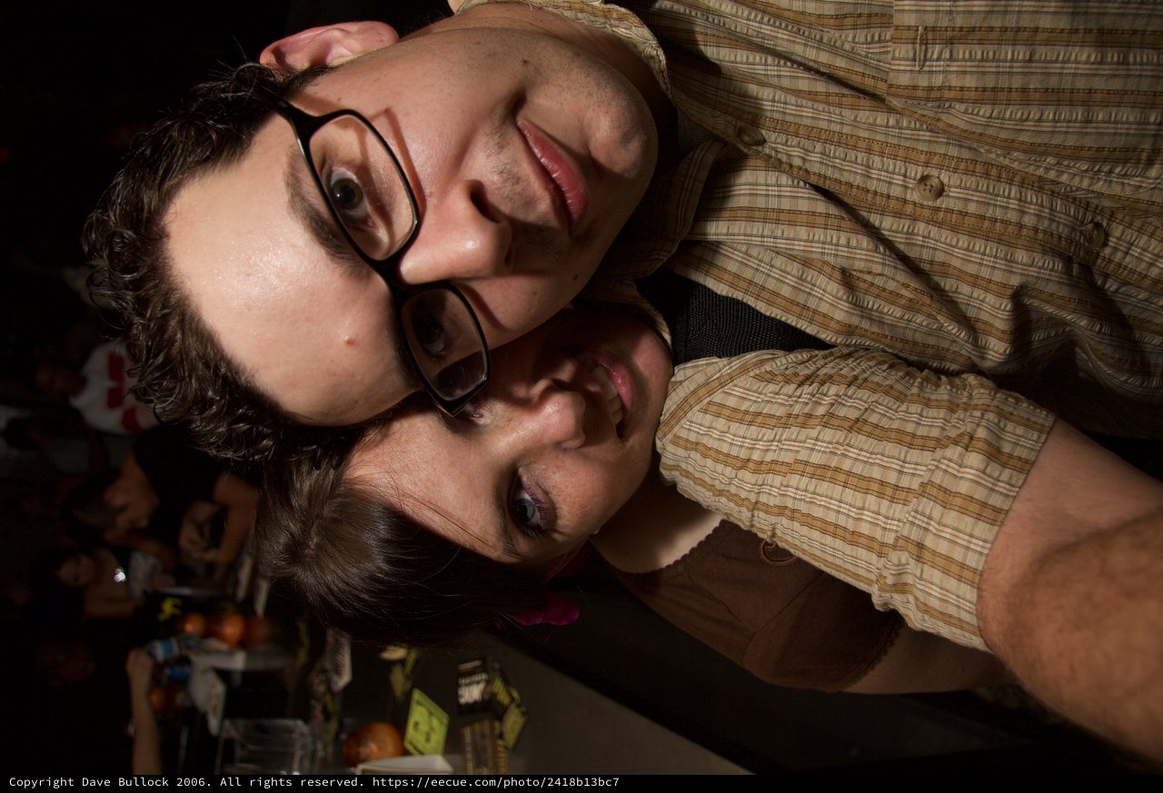 Two Friends Pose Close Together at Night Event
