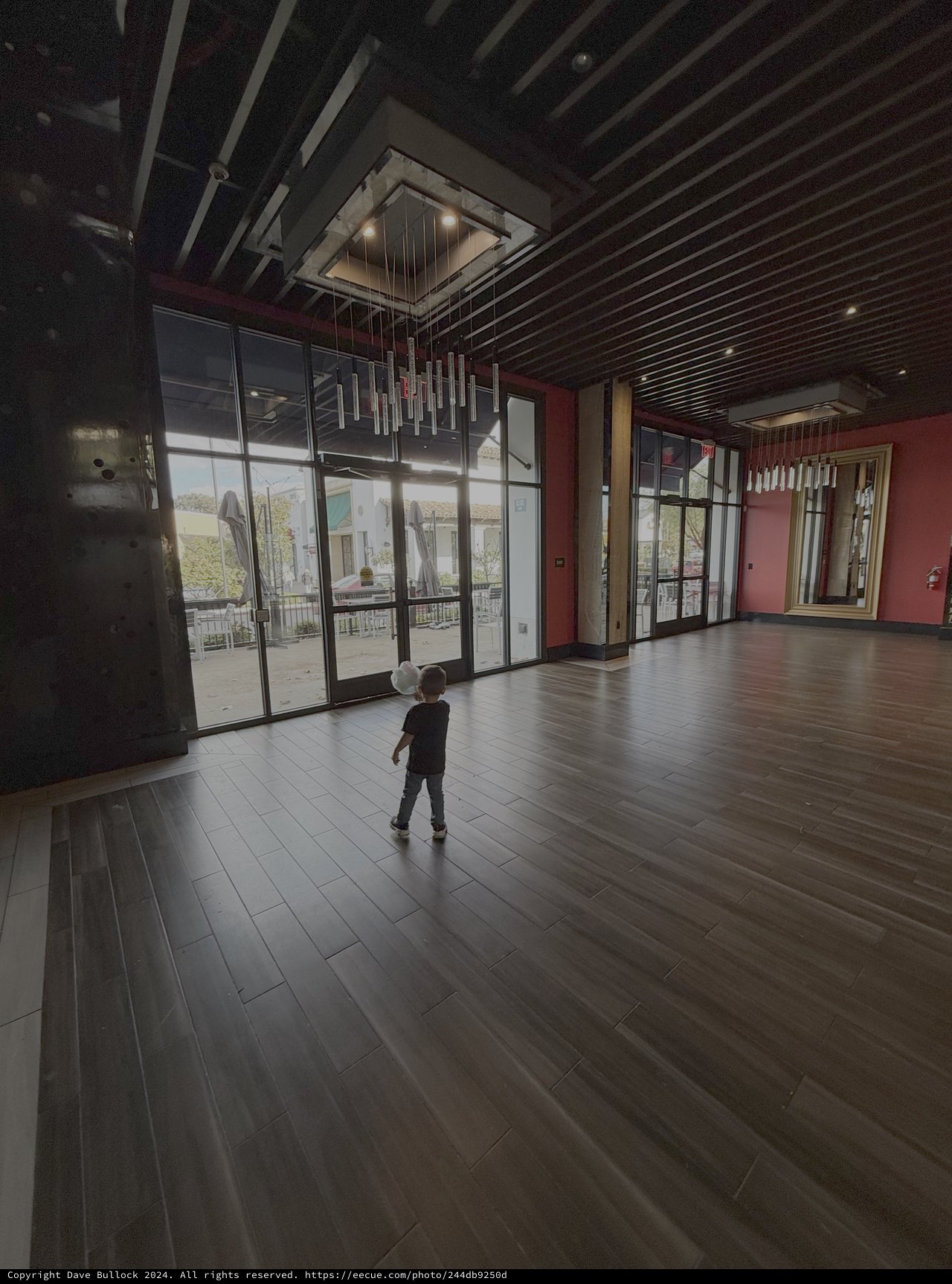 Child Explores Modern Restaurant Interior Space
