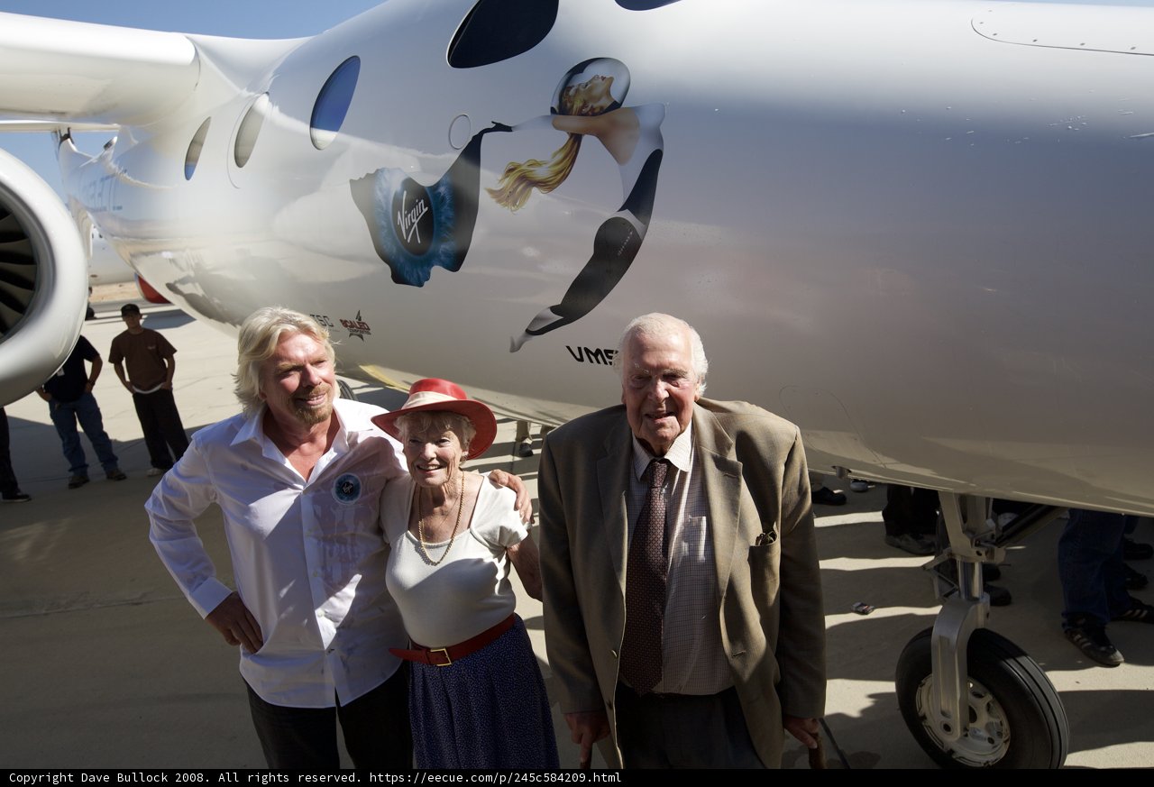 Richard Branson and Companion in Front of Aircraft at Airport