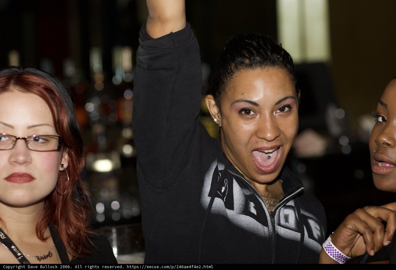 Three Women Strike a Pose in Urban Nightlife Scene