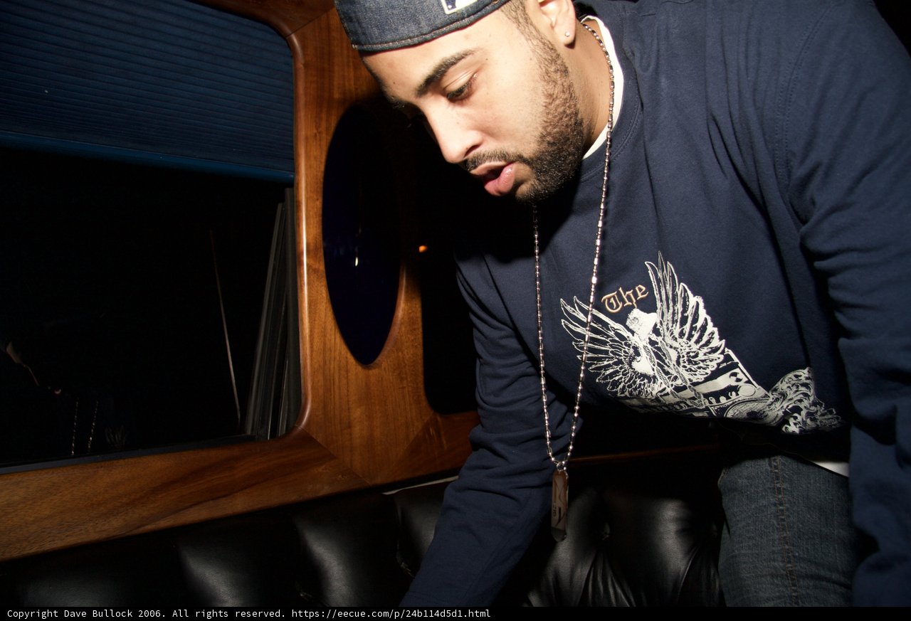 Blue-Shirted Man in Baseball Cap on Couch