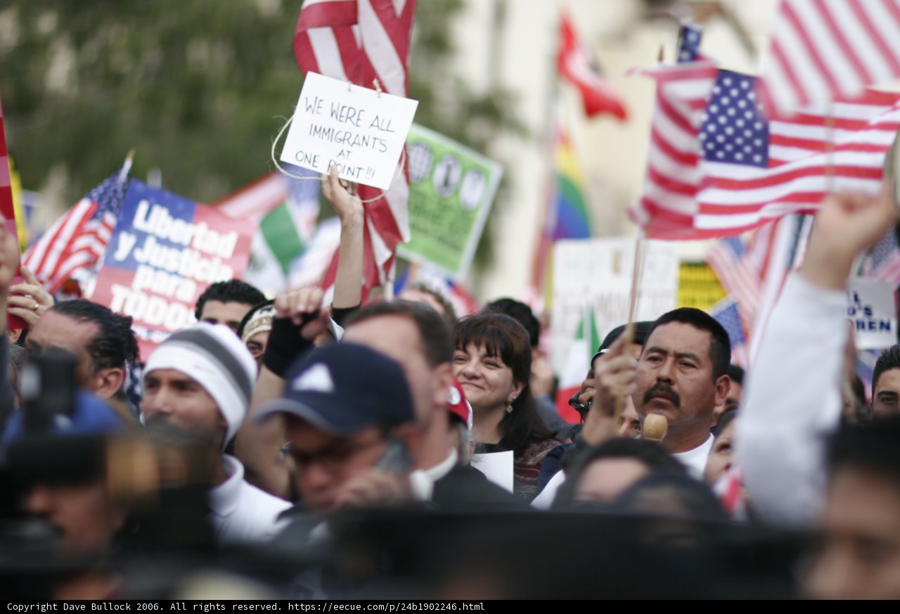 American and Mexican Flags Held by Crowd