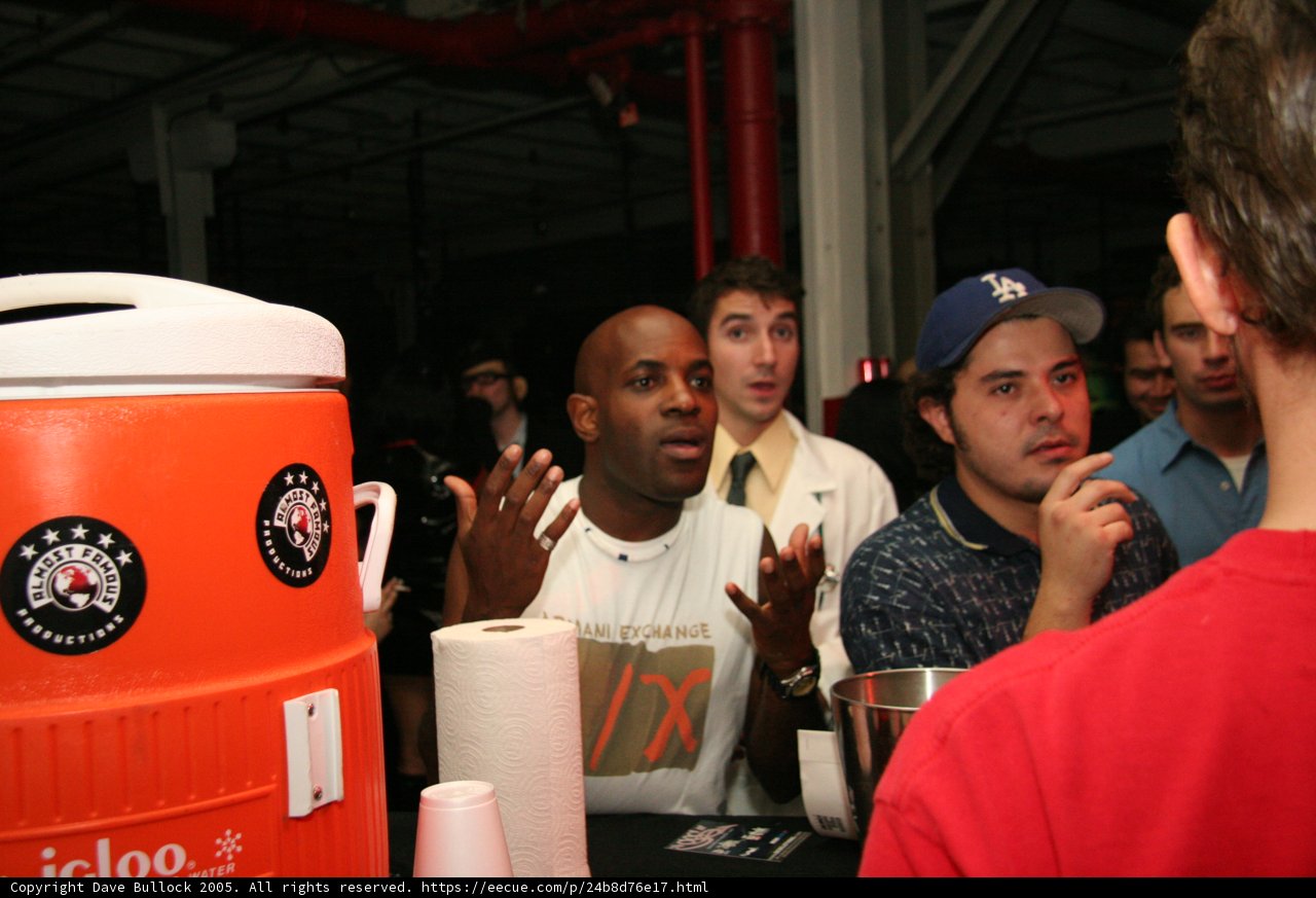 Red Shirted Man Enjoys Beverage