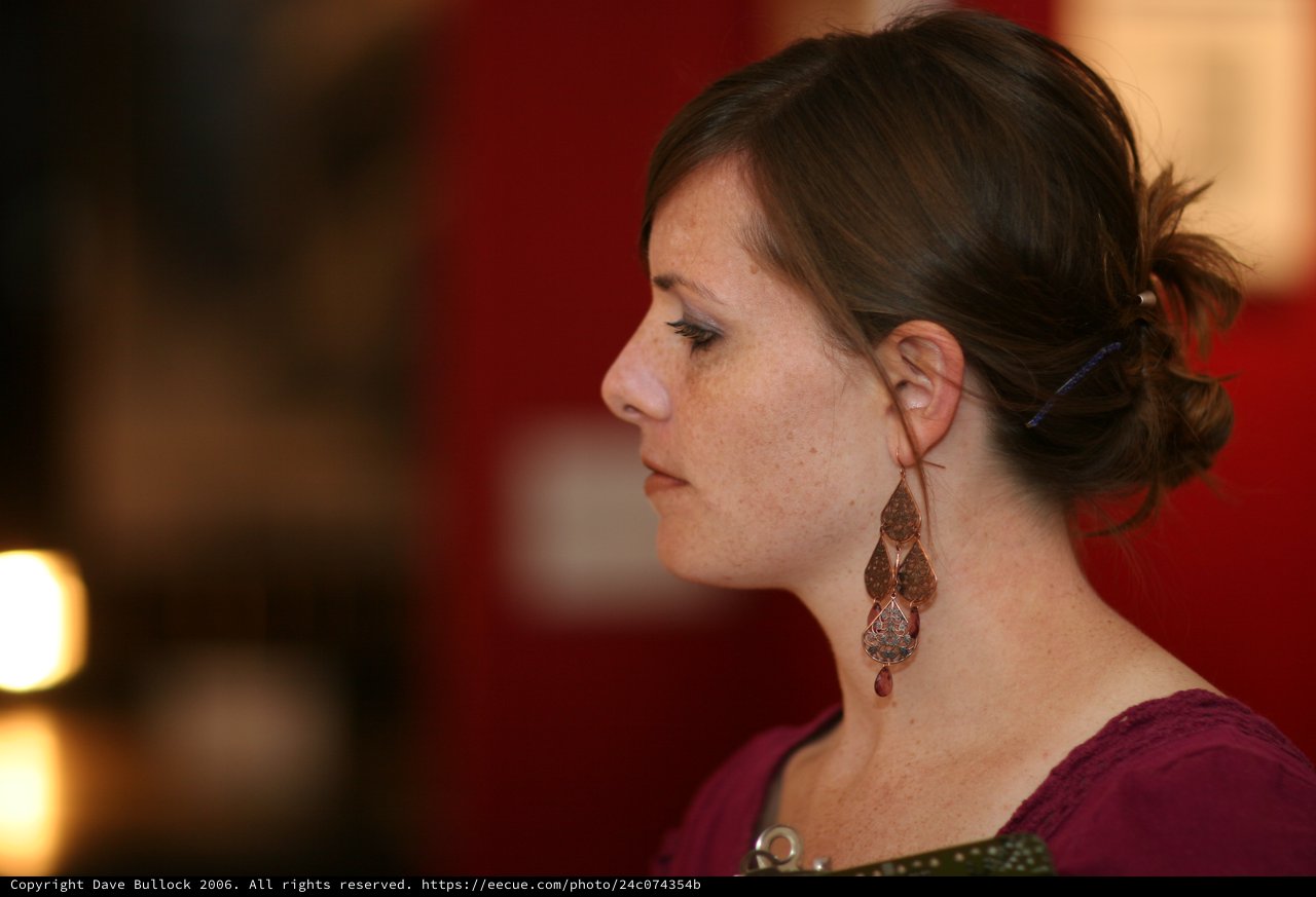 Contemplative Woman in Profile at Art Walk