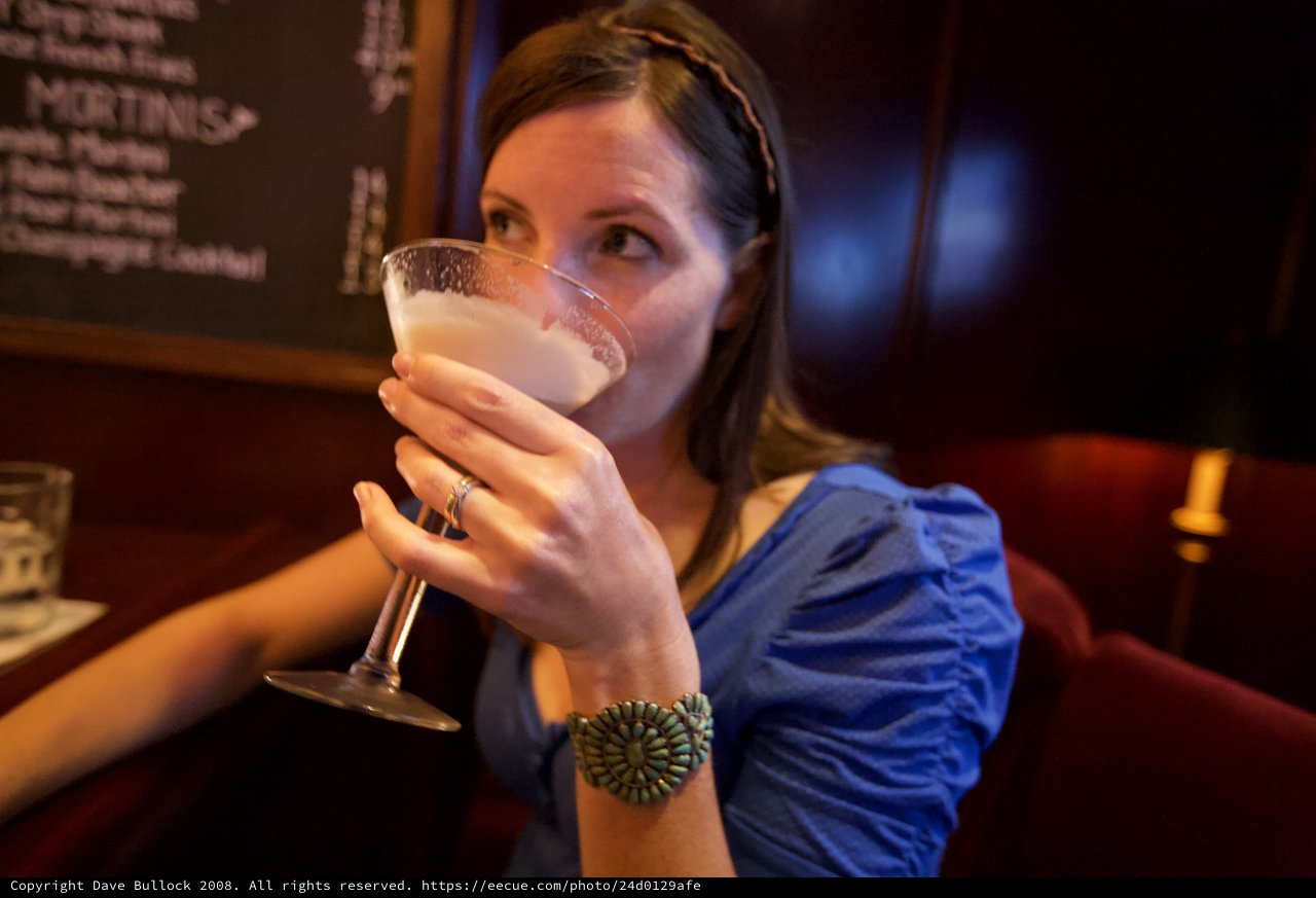 Woman Sipping Cocktail at Upscale Martini Bar