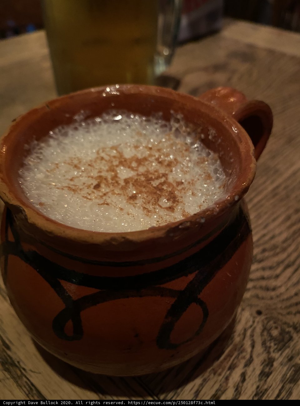 Brown mug and spoon of milk