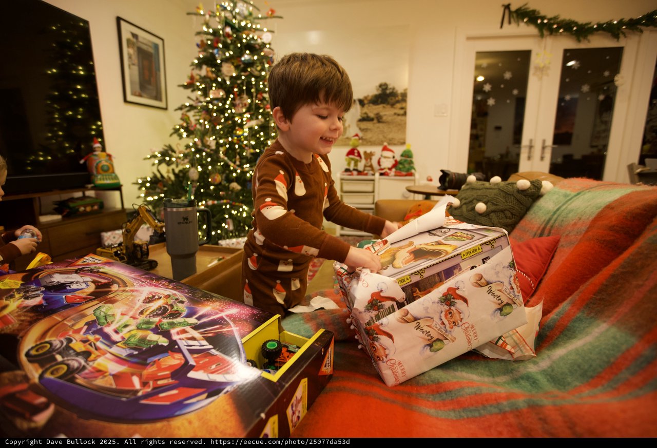 Christmas Morning Joy: Boy Unwrapping Presents