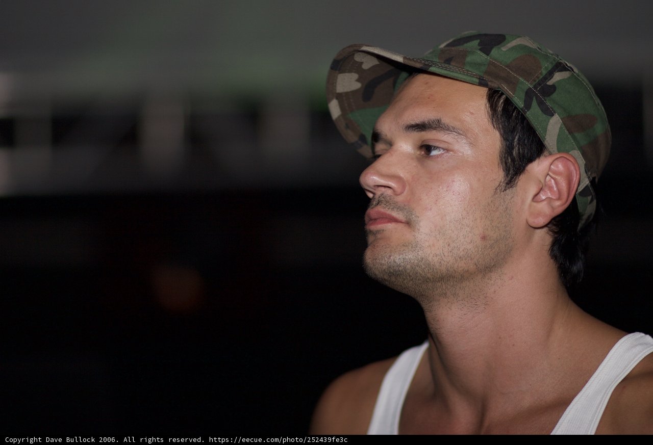 The Stylish Man in a Hat and Tank Top