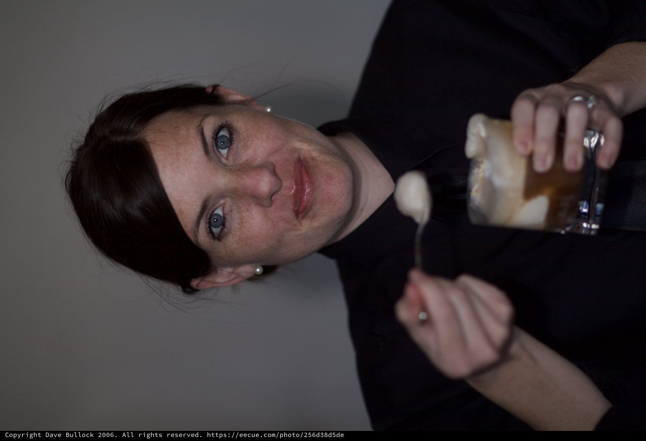 Woman Savoring Dessert with Playful Expression
