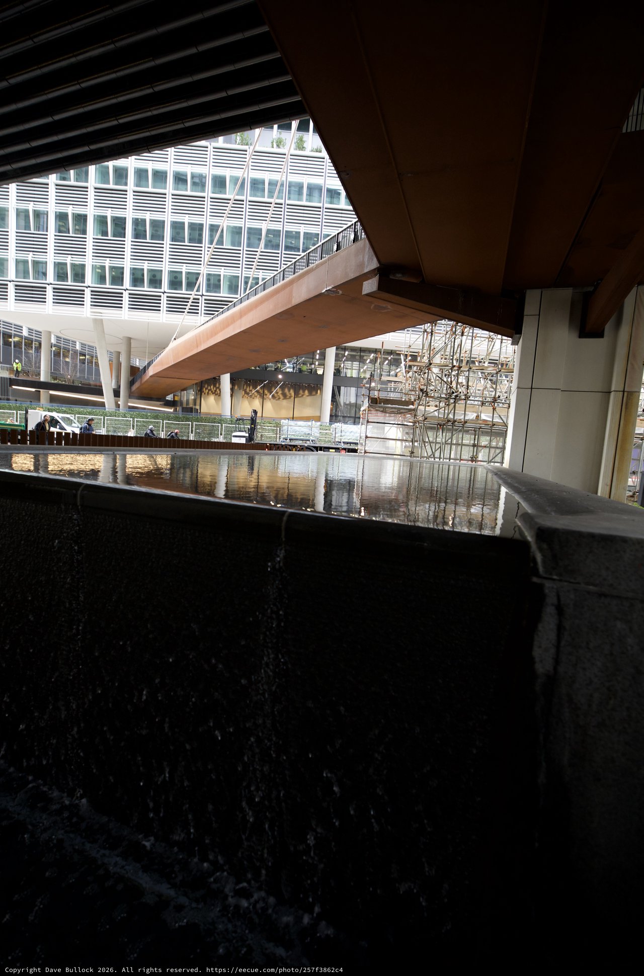Reflective Pool Under Modern Architectural Canopy in London