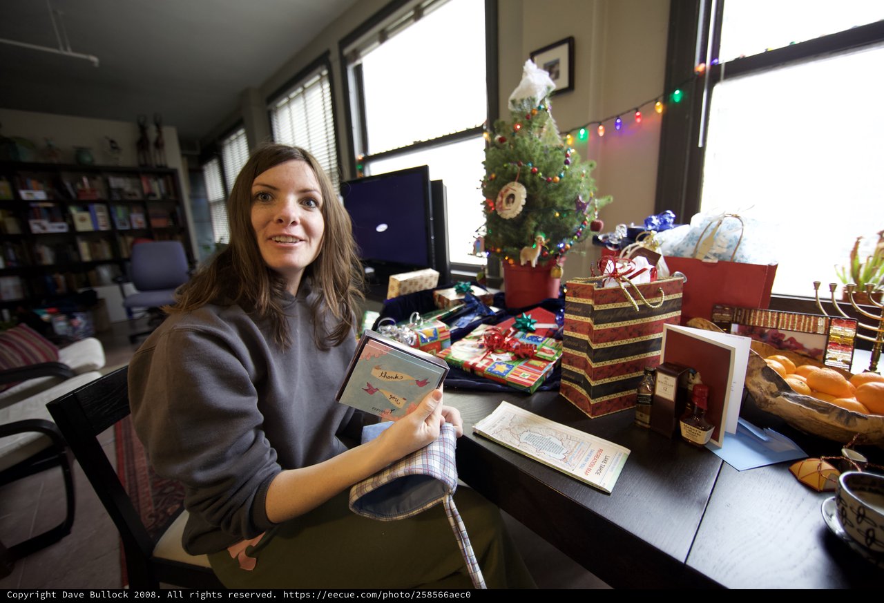 Woman Celebrates Christmas Morning with Gifts and Cards