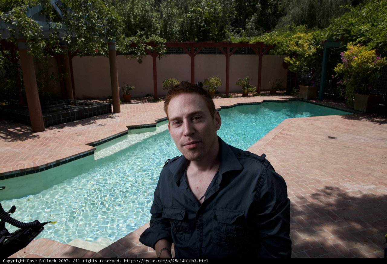 Man Relaxing by Resort Pool