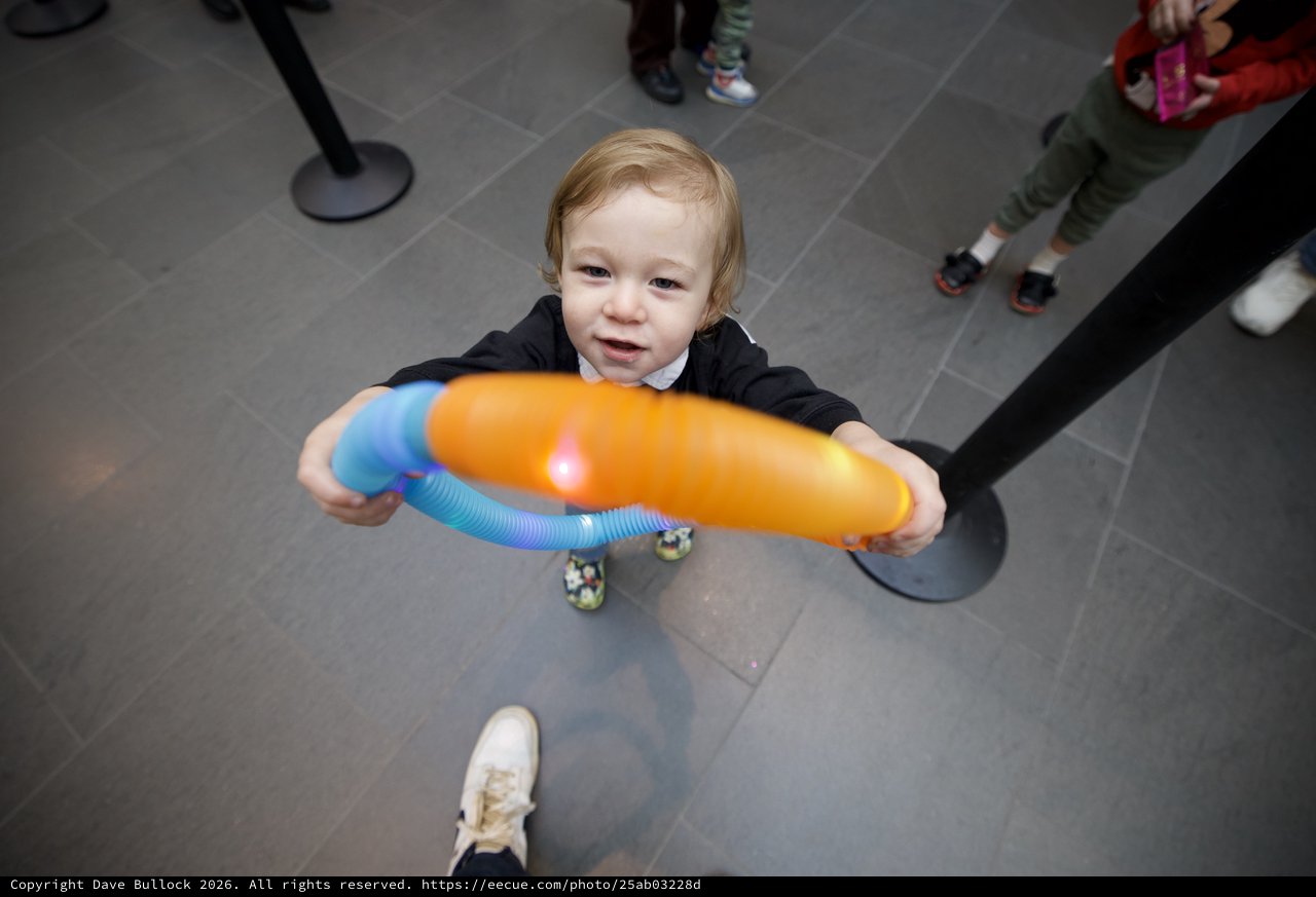 Toddler with Colorful Toy at Baby Rave Event