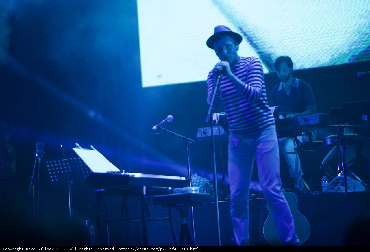 Belle and Sebastian Stuart Murdoch Singing Fedora Striped Shirt Bearded Keyboardist Blue Stage