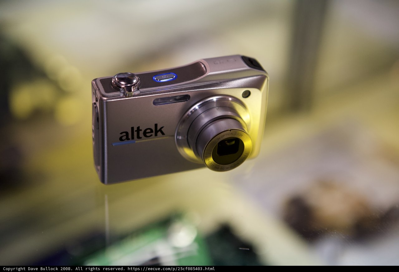 Shiny Silver Digital Camera in Glass Display Case